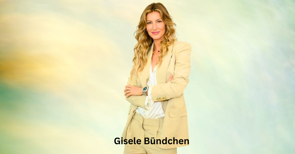 Gisele Bündchen standing confidently with her arms crossed, wearing a light beige suit with a white shirt underneath. She has long, wavy blonde hair and a soft smile. The background is a soft gradient of pastel colors, creating a calm and serene ambiance.