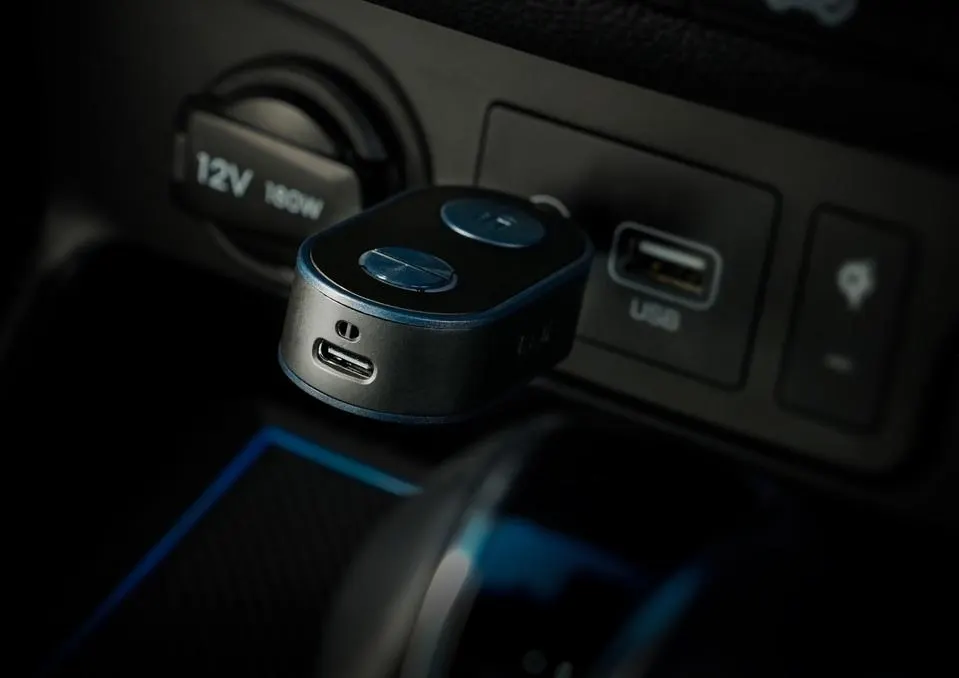 iFi UP Travel plugged into the AUX input of a car stereo.