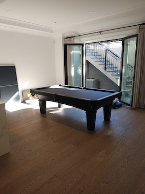 Pool table in a sun-filled lower-level suite.