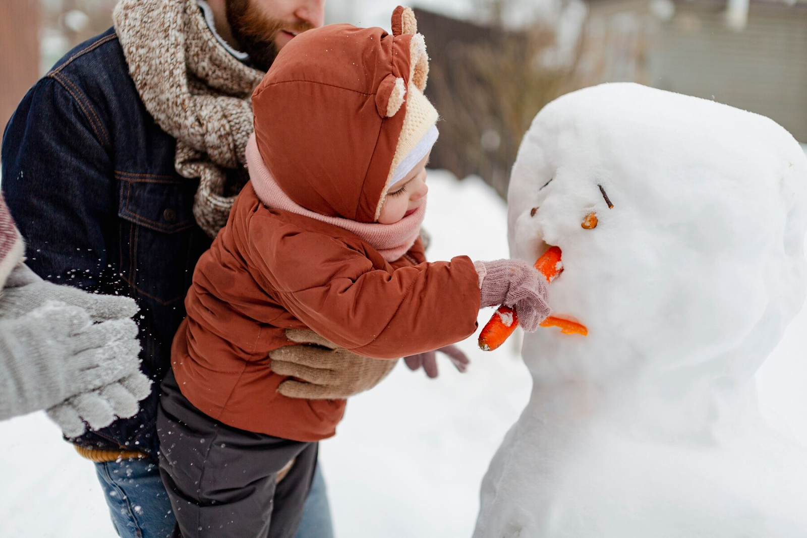 child enjoying winter activities with their family