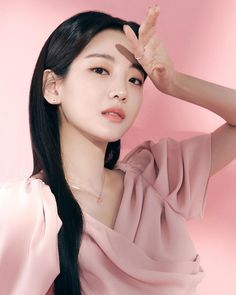 This contains an image of  Choi Joung Yun,  on a pink dress with her hand on her forehead