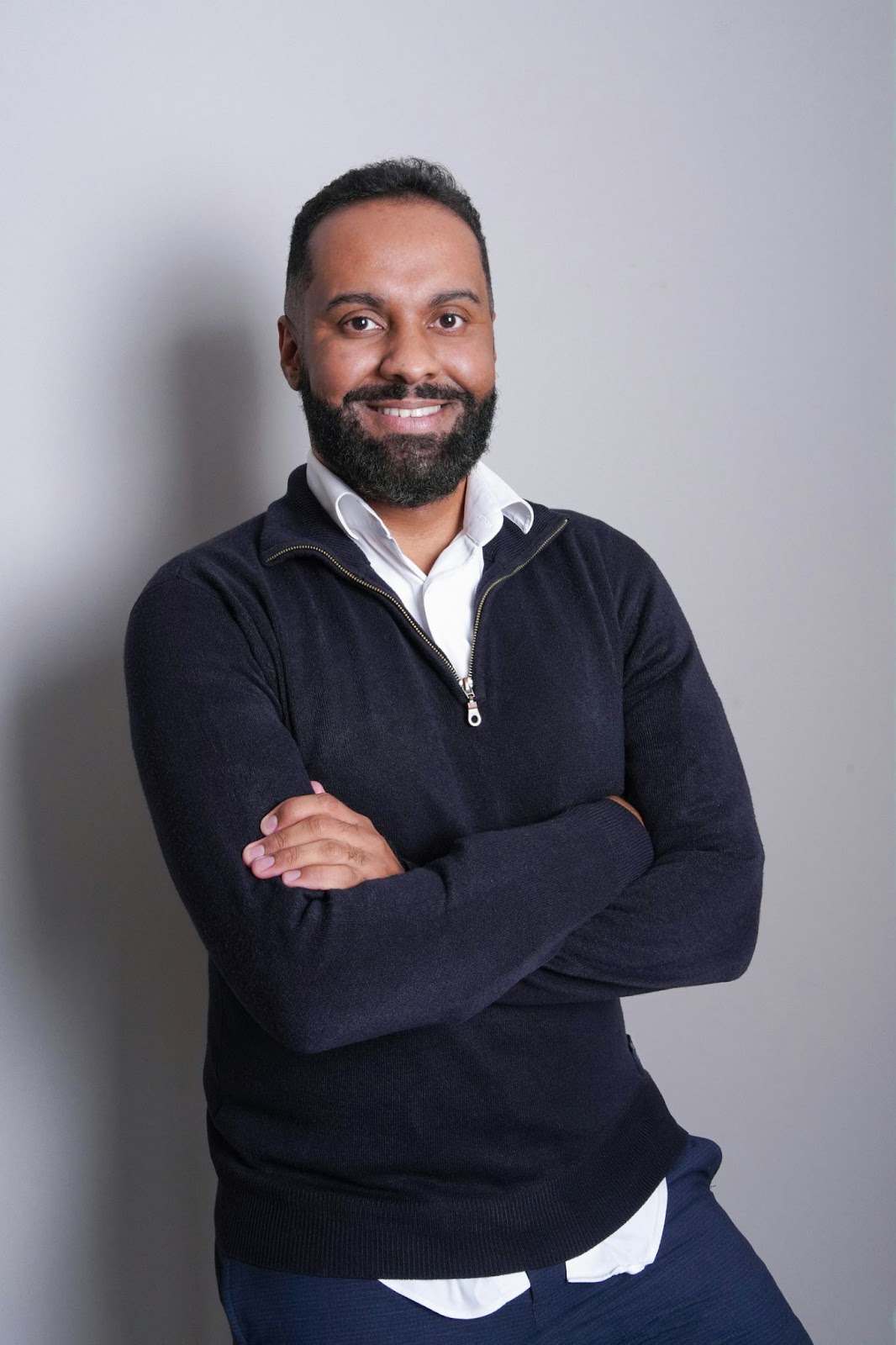 The classic headshot pose against a solid background