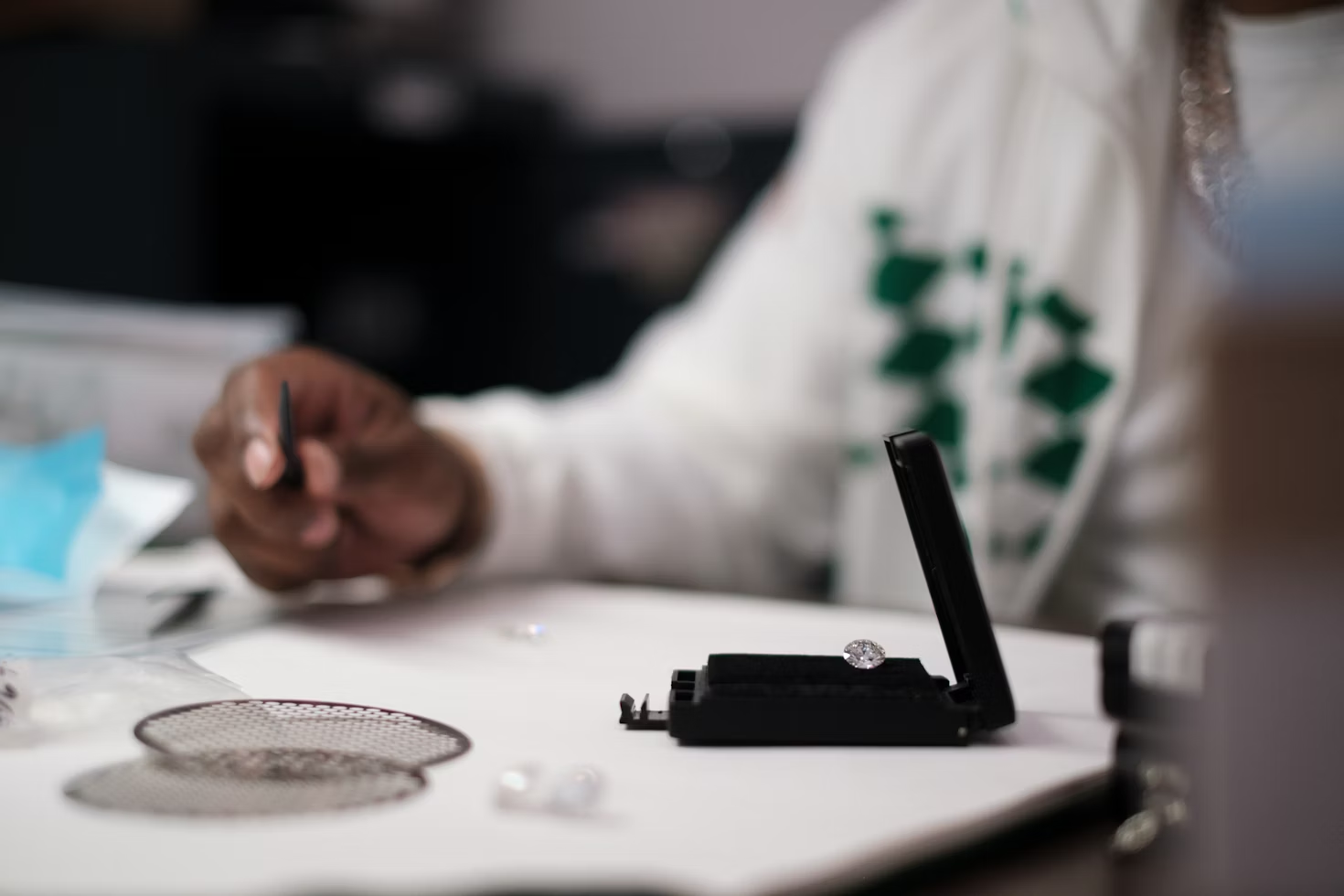 A person examining a diamond.