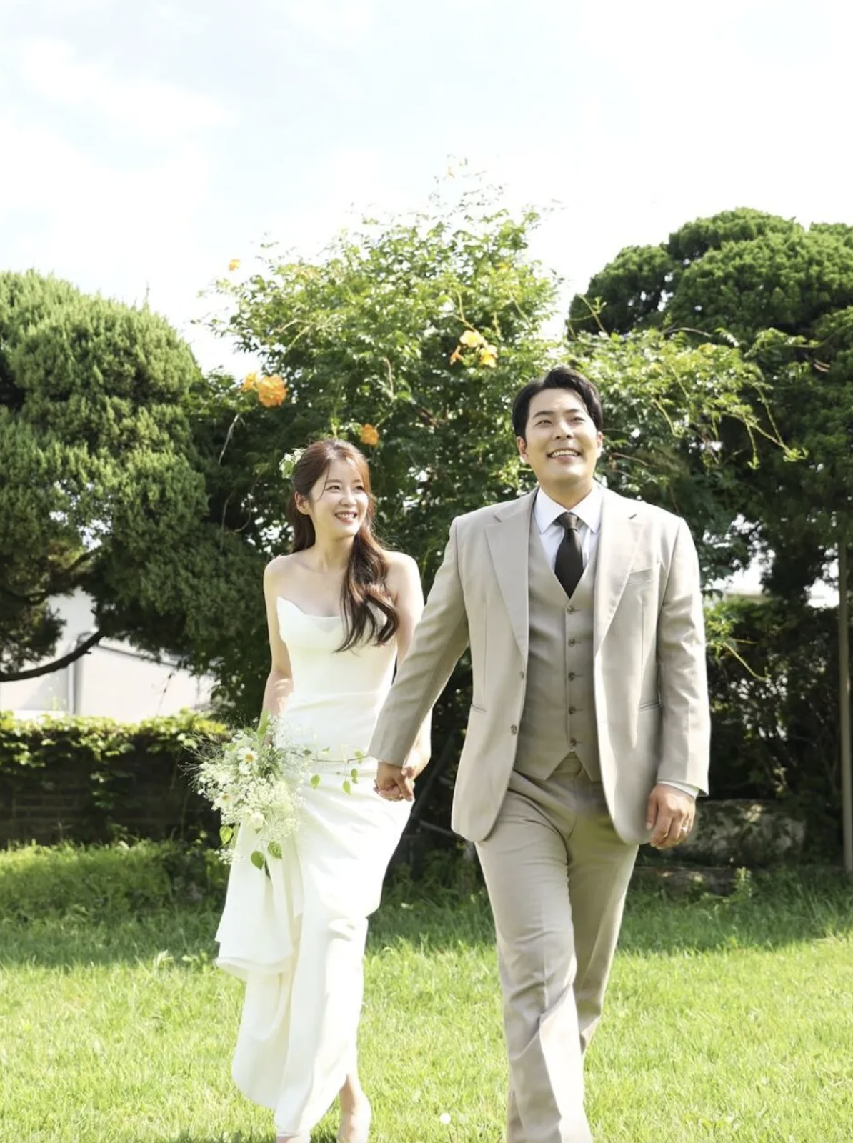 This contains an image of  Kim Hae Jun on a suit and  Kim Seung Hye on a wedding gown