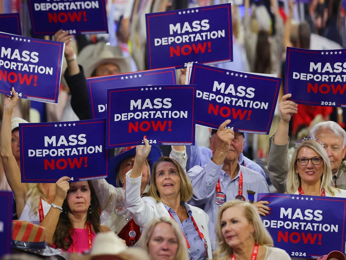 People holding signs that read 'Mass Deportations Now'