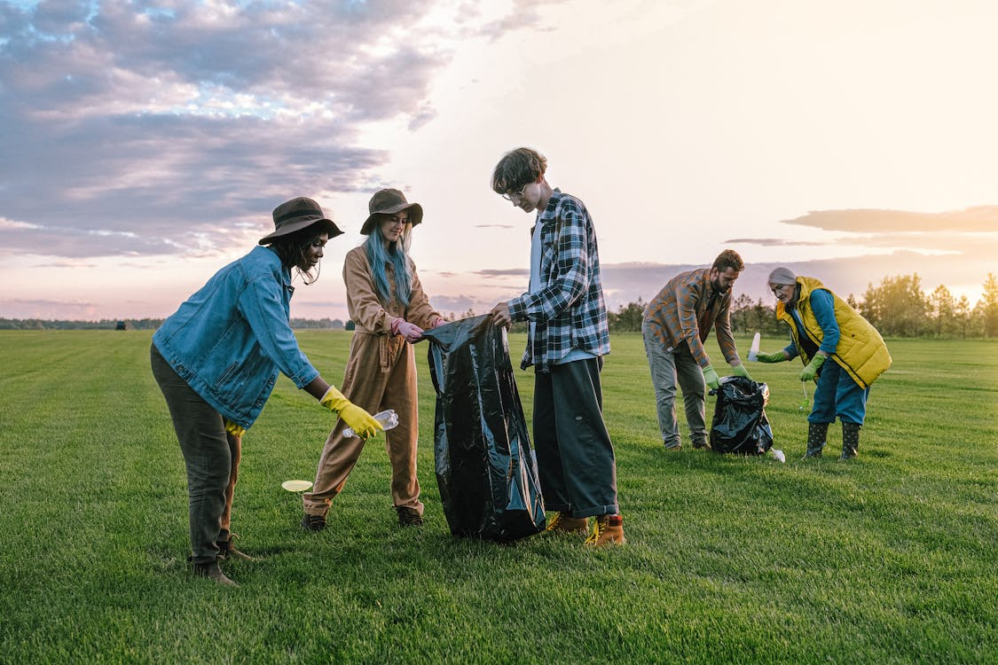 https://www.pexels.com/photo/volunteers-collecting-trash-on-green-grass-field-5029859/ 