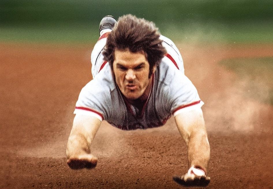 A baseball player sliding on the ground

Description automatically generated