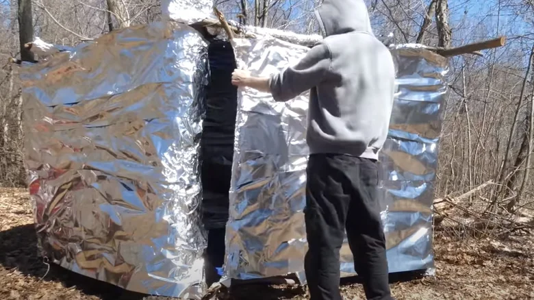 Aluminum foil used used as a shelter as a Survival Hacks Using Common Household Items for Camping
