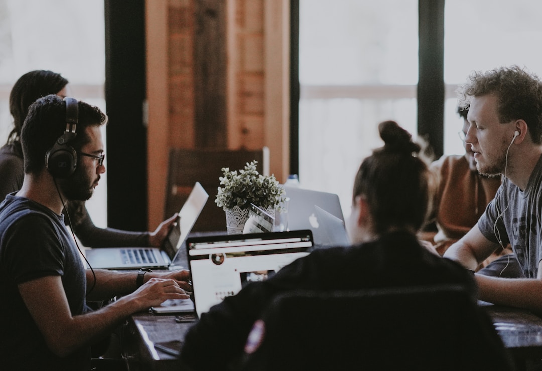 imgTeam members engaged in a discussion on how machine learning improves search relevance and accelerates information retrieval in business environments