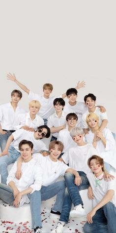 This contains an image of members of SEVENTEEN all in white polo an blue jeans 