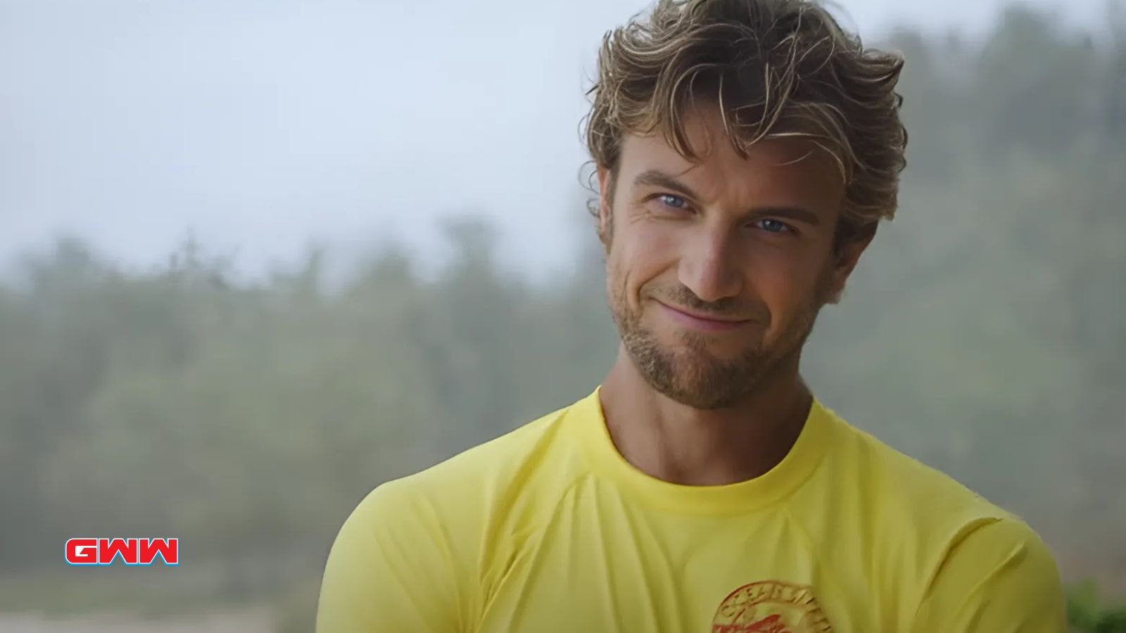 Adam Demos smiling in his lifeguard uniform in Rescue Hi Surf