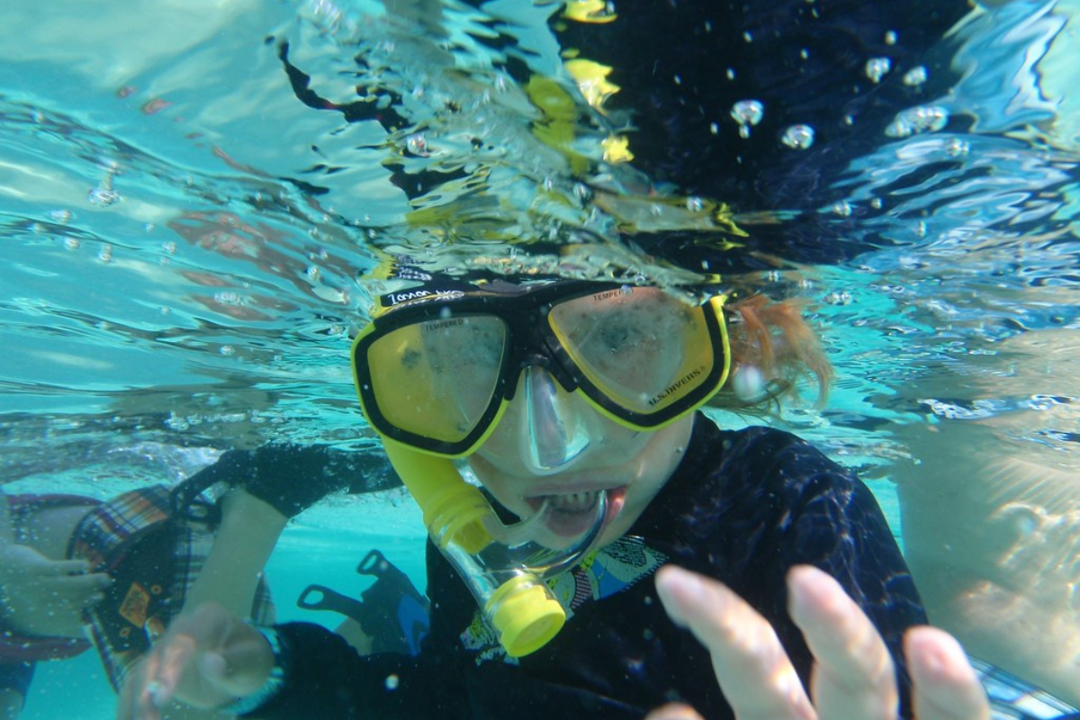 A person enjoying snorkeling under water 