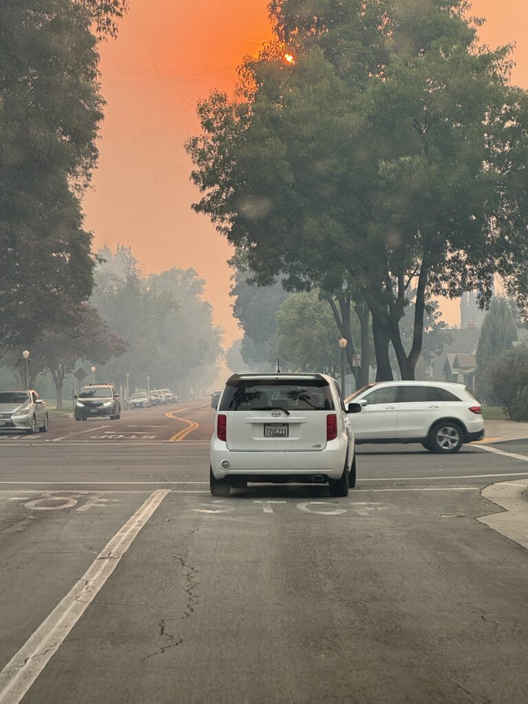 A cloud of haze covers the street in Redlands as a result of the Line Fire