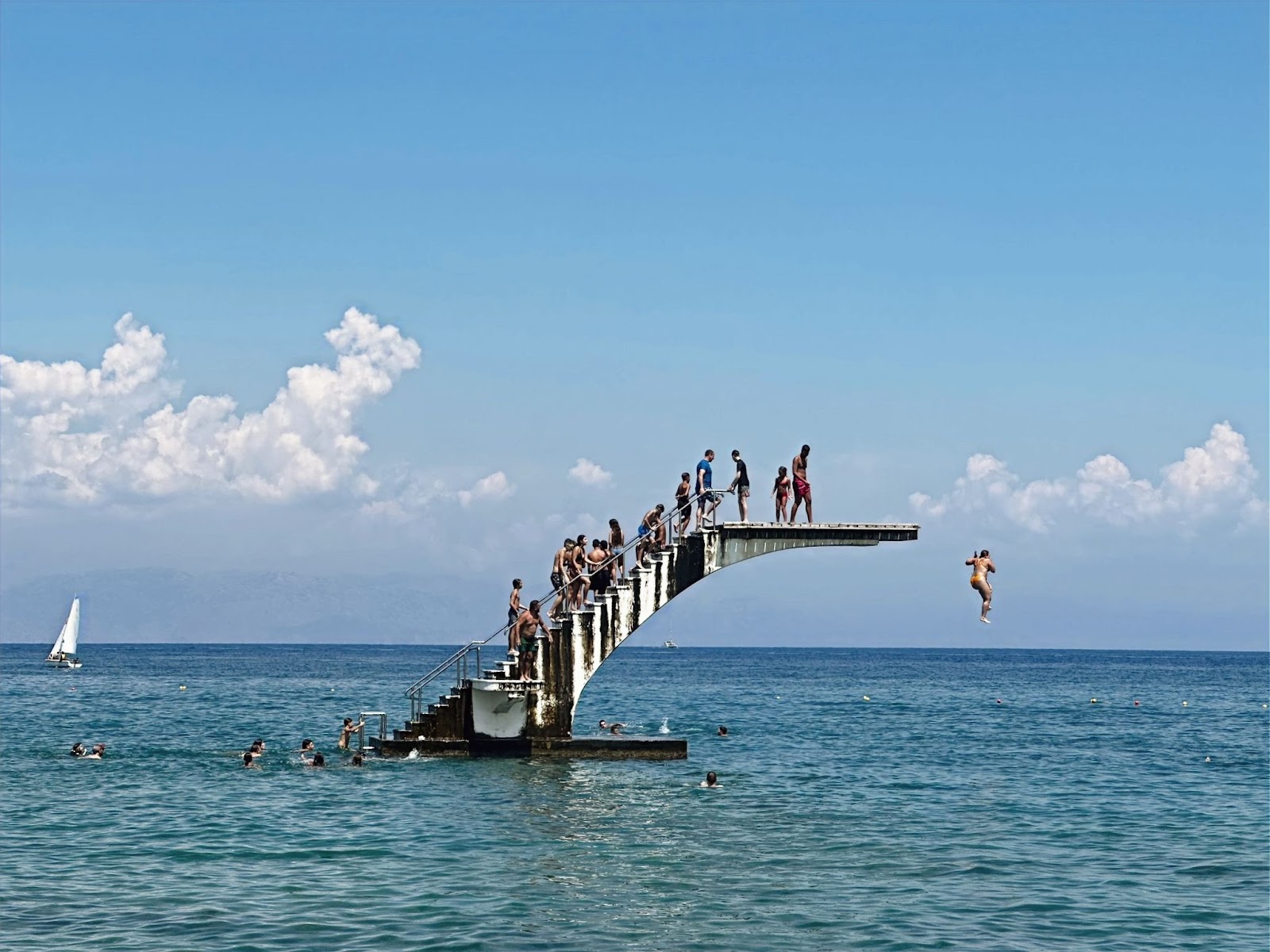 Rhodes Old Town, people jumping off a structure into the water in greece