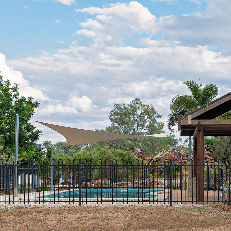 black wrought iron fence surrounding a backyard swimming pool