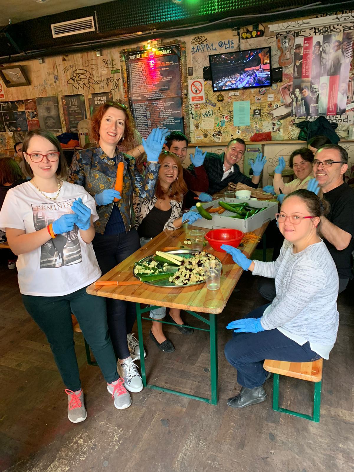 A group of people sitting at a table with food on it

Description automatically generated with medium confidence