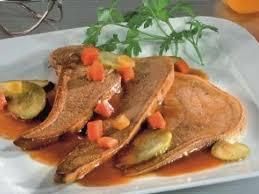 A plate of meat with vegetables

Description automatically generated