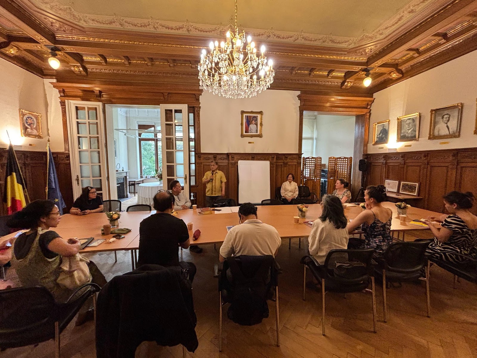 A group of people sitting around a tableAI-generated content may be incorrect.