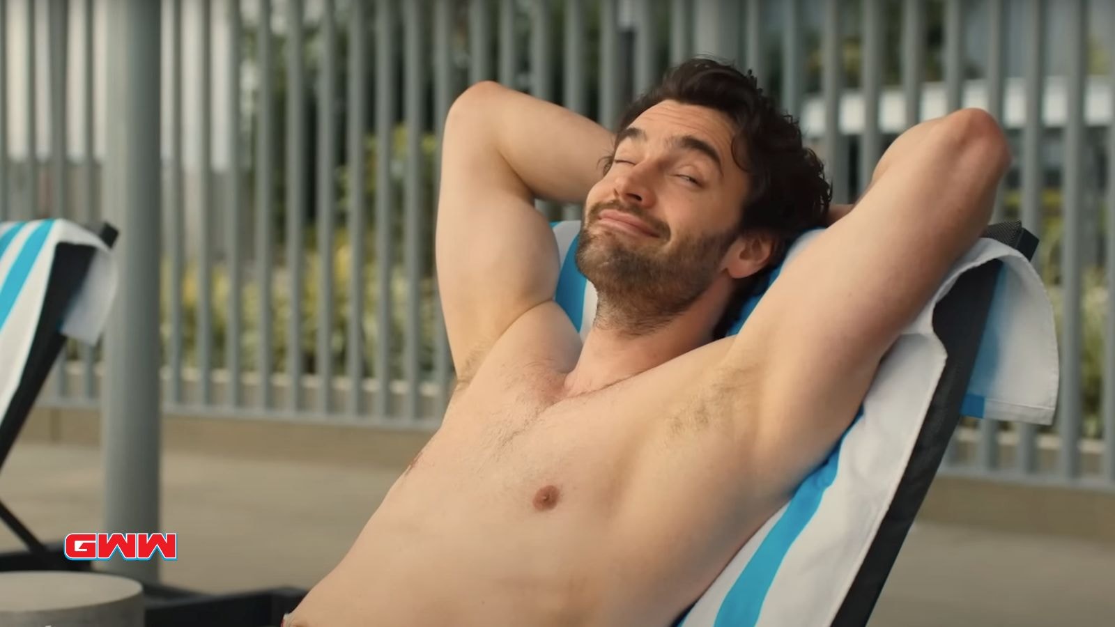 Matt relaxing on a lounge chair, smiling confidently.