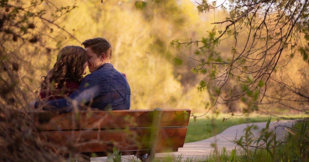  A couple sitting on a bench and observing nature as one of the cheap romantic date ideas for married couples