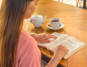 girl reading a book and drinking tea, habit blog, create new habits, counseling center at cinco ranch, katy texas