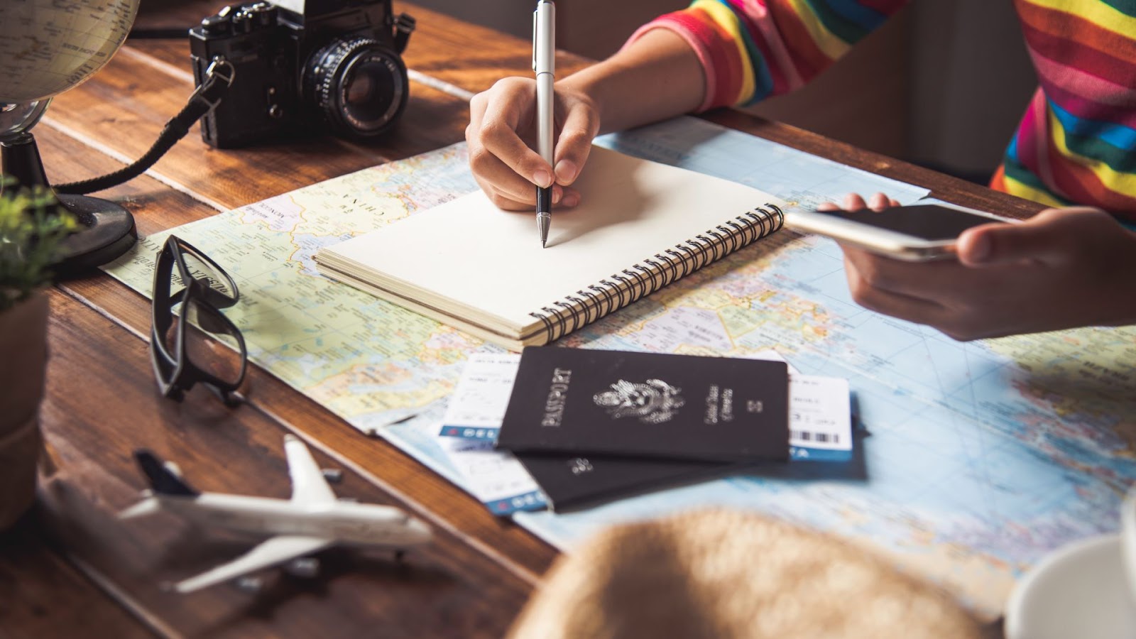 Travel planning with a map and a notebook