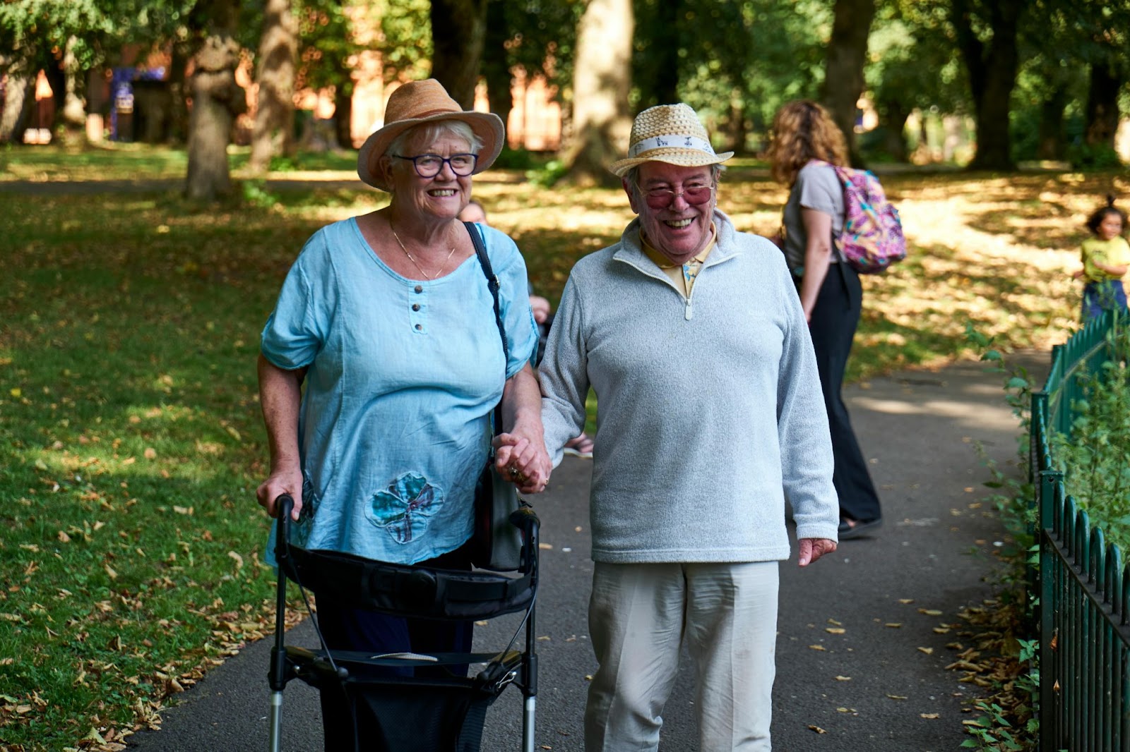 Two happy seniors walking in the park