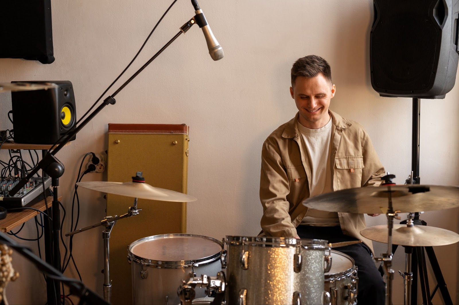 Adult man practicing drums in a beginner drum course in London