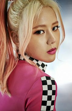 this is a photo of AOA  Hyejeong with a blond hair and she is putting on a pink dress 