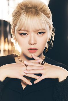 This contains the image of JEONGYEON on a black dress with both hands put together