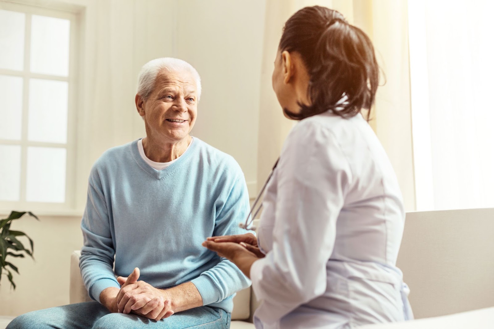 A healthcare provider speaking to an older adult in a senior community.