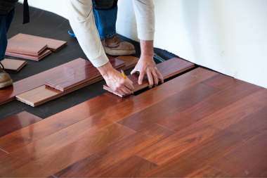 hardwood vs luxury vinyl flooring comparing interior upgrades home remodeling contractor installing floorboards custom built michigan