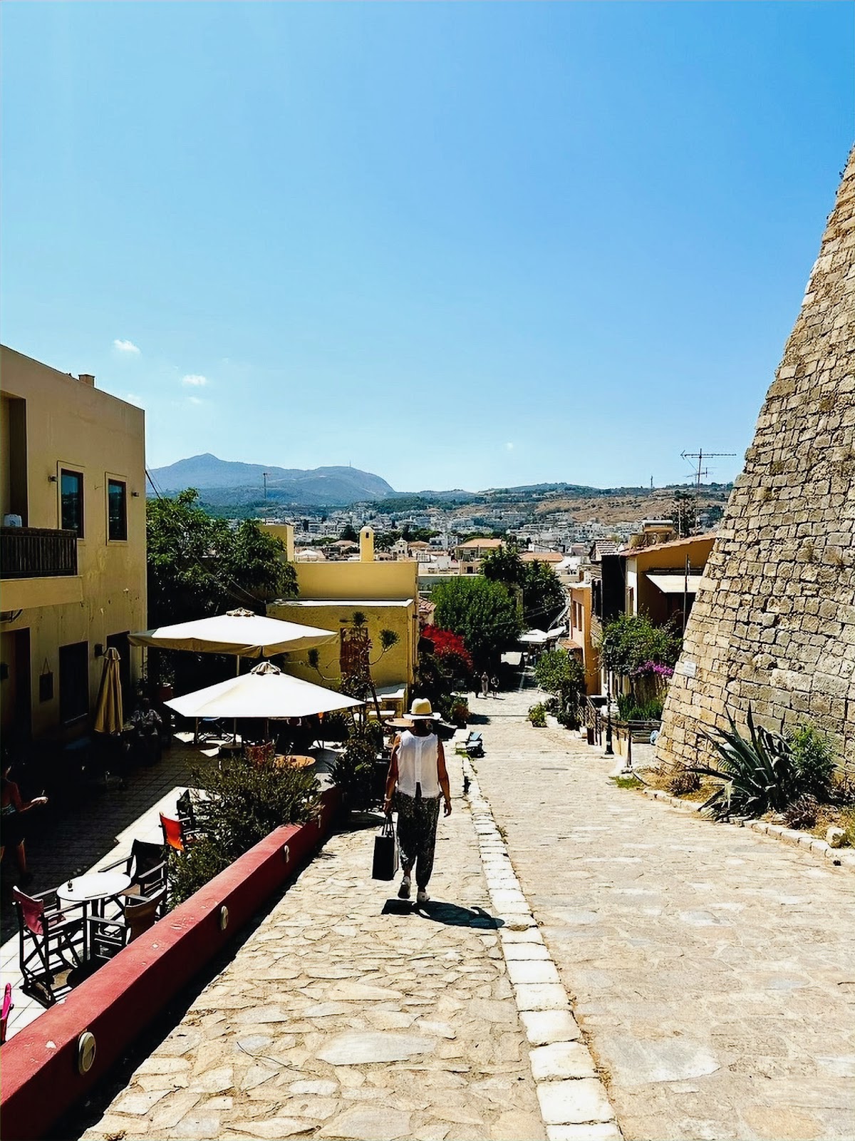 Rethymnon (Crete) Old Town, woman walking with luggage in town