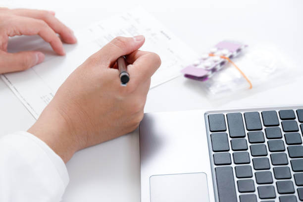 A pharmacist jotting down notes while preparing customized medications tailored to meet unique health needs.