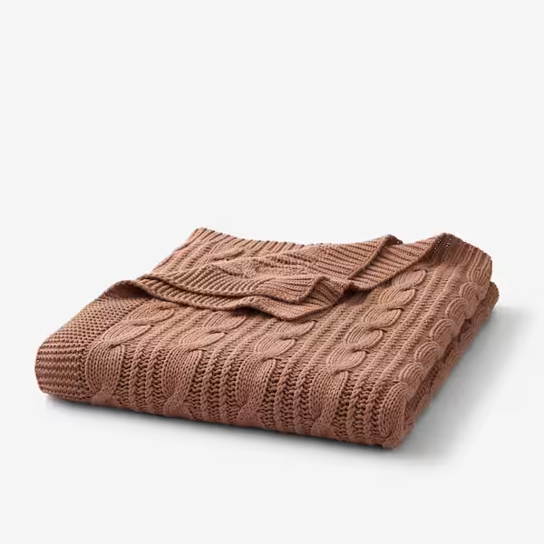 The Company Store Chunky Cable Knit Cotton Throw combines cozy 100% cotton with OEKO-TEX certification, perfect for layering and lounging.