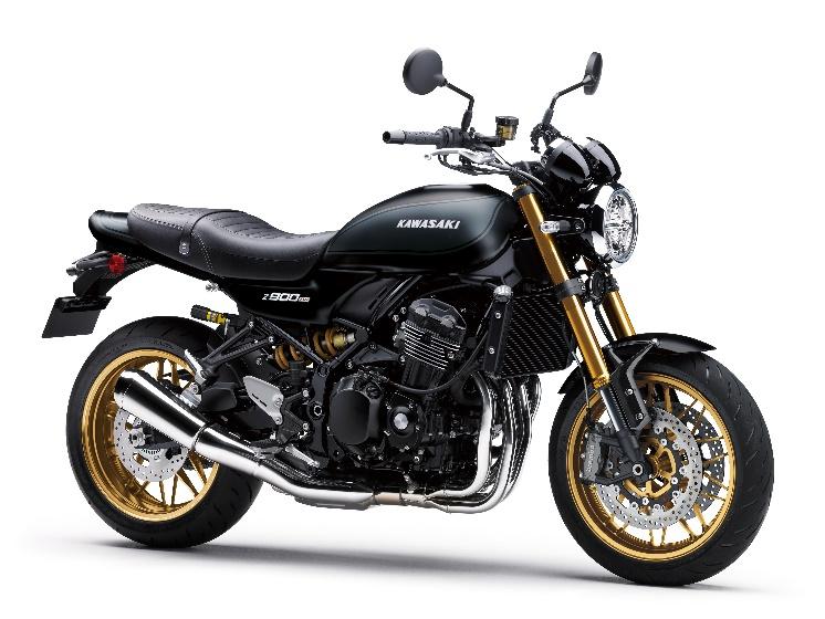 A black motorcycle with gold rims

Description automatically generated