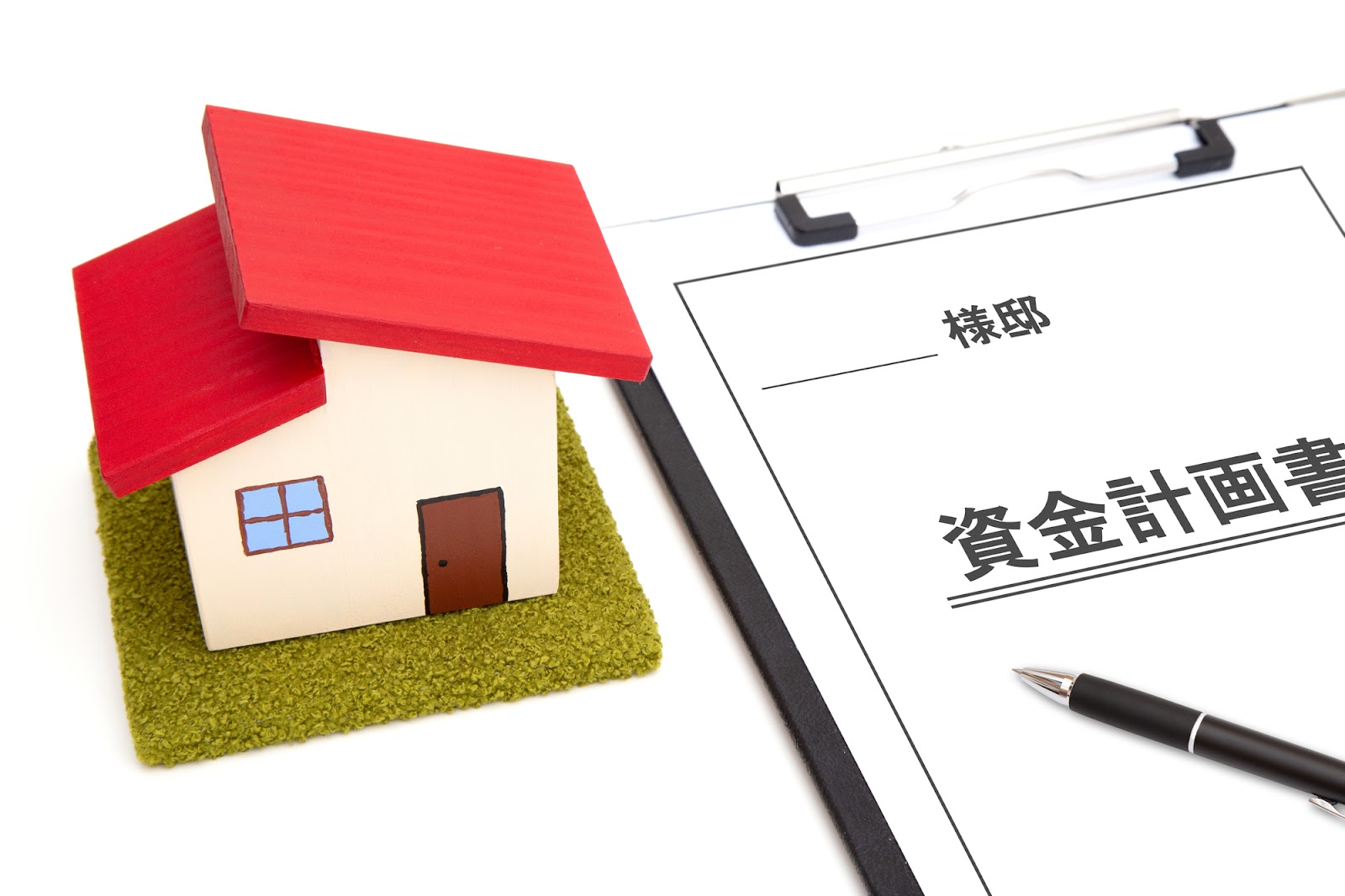 資金計画書と住宅模型で家づくりの予算を立てるイメージ