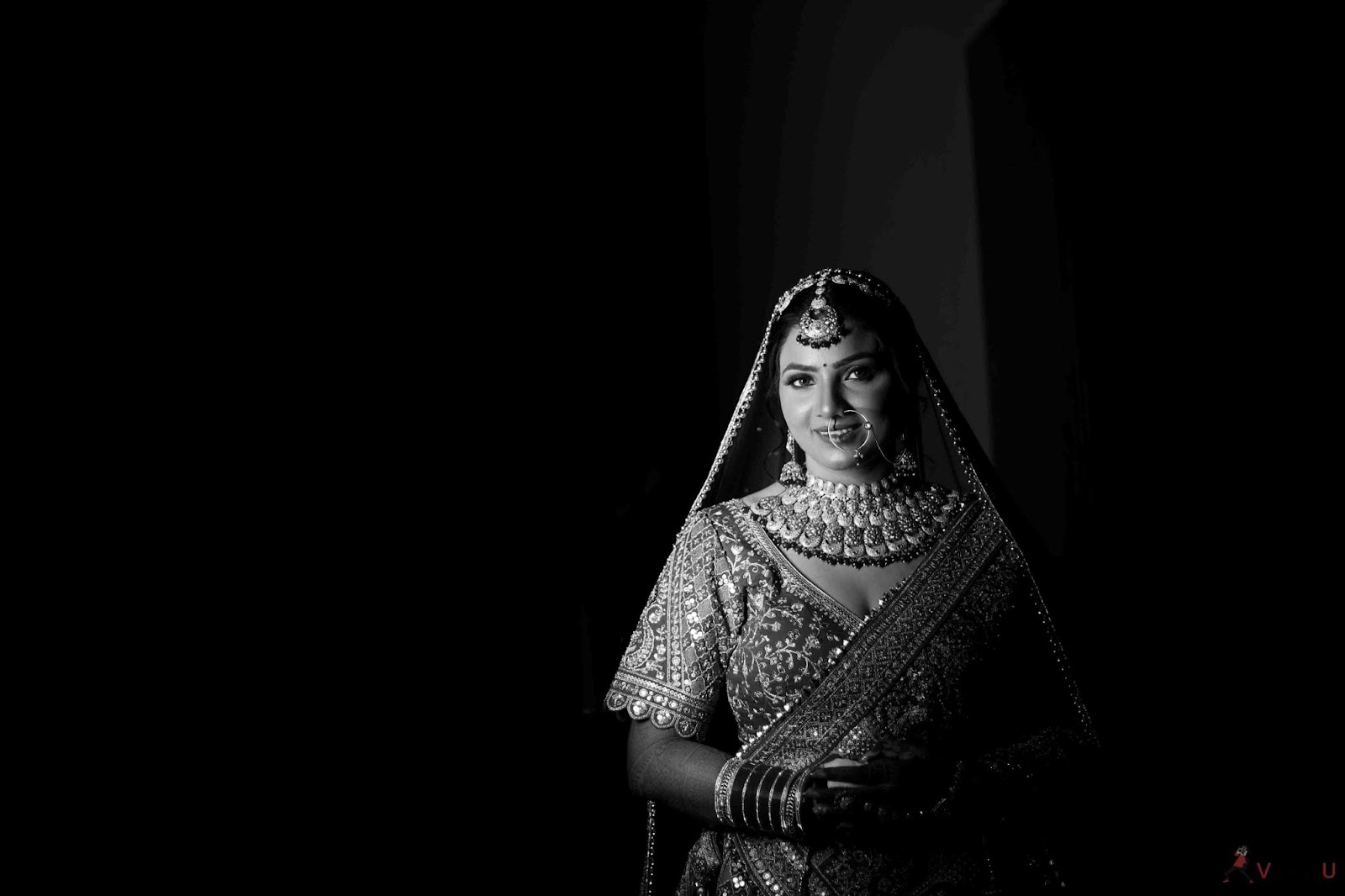 Elegant black-and-white portrait of a bride in full wedding attire, capturing timeless beauty for 2025 trends