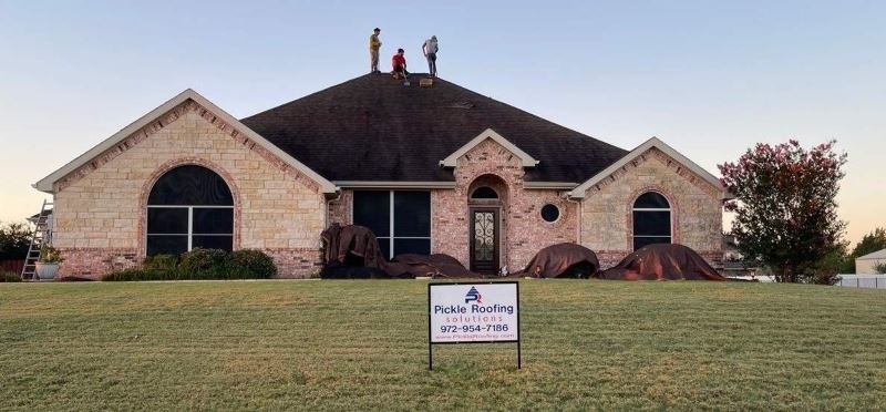 Workers from Pickle Roofing Solutions fixing a roof