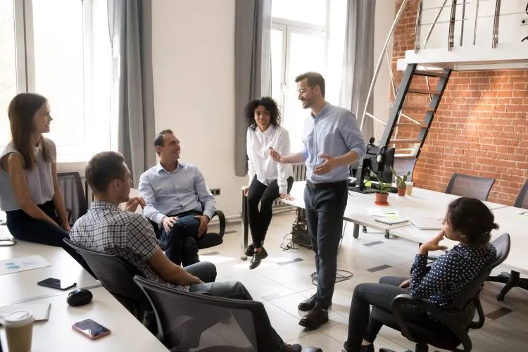 A leader discussing and providing guidance to his teammates during work hours