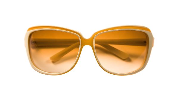 how orange lenses filter blue light: An orange colored pair of glasses