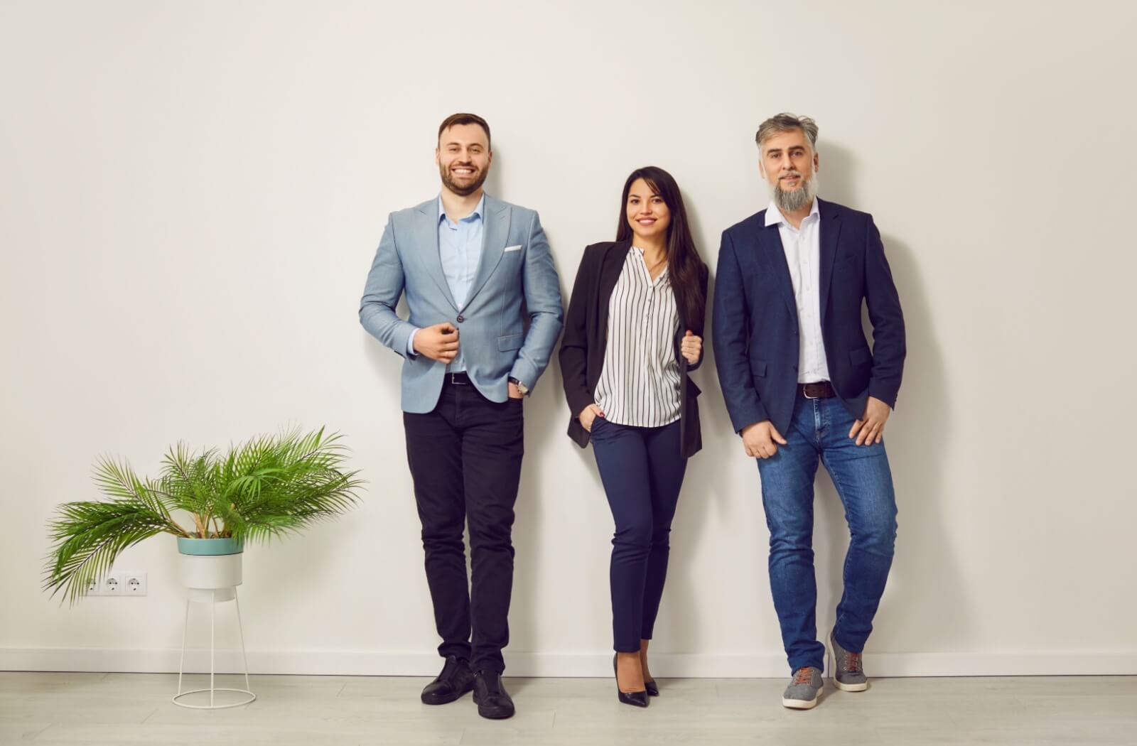 A business team demonstrates various ways to dress up jeans for a business casual dress code at work.
