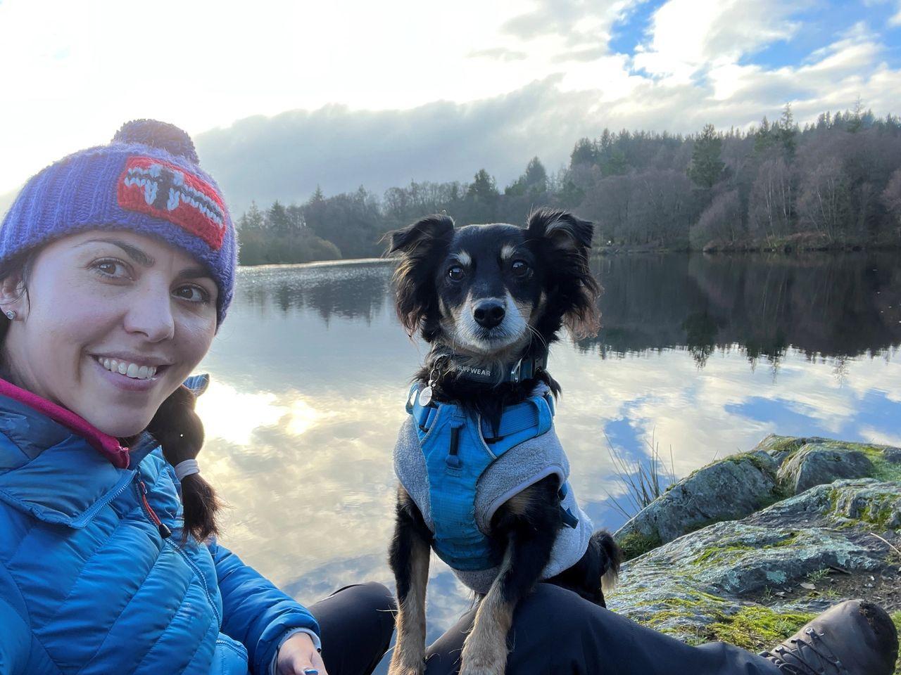 Rachel with Rico a 7 year old kokoni wearing a fleece under his harness
