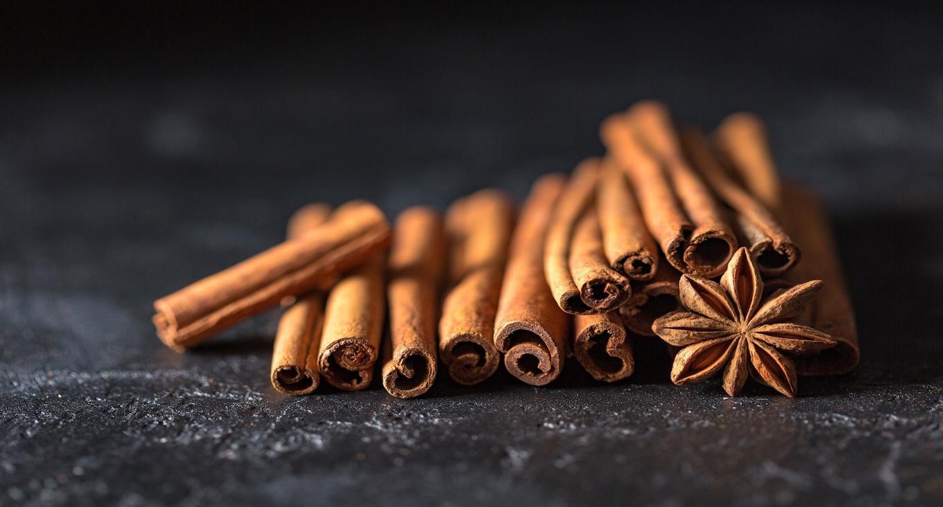 A group of cinnamon sticks and anise

Description automatically generated