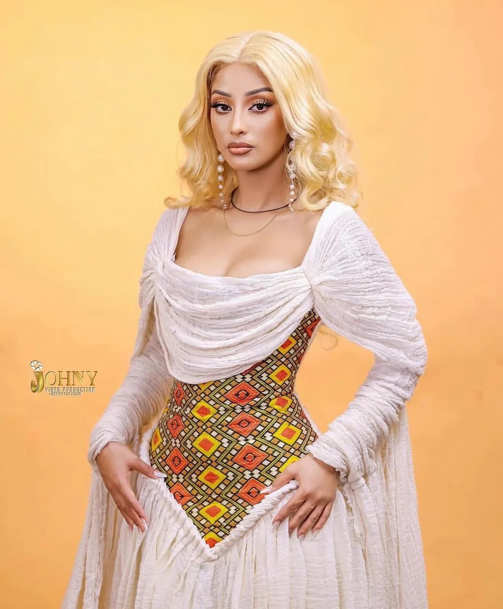 Woman wearing Habesha dress with modern styled cuts