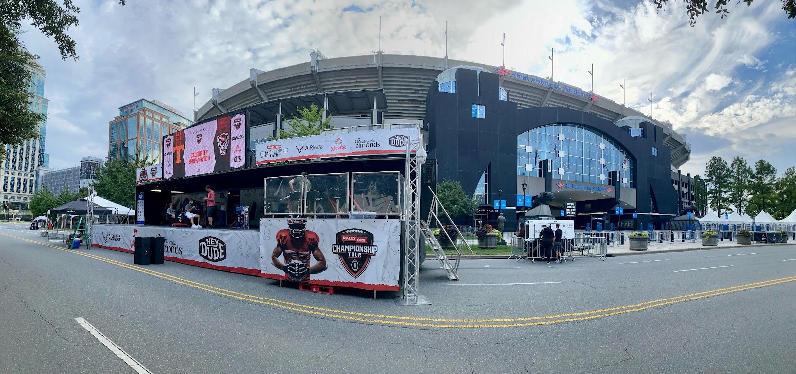 A stadium with a football decoration booth outside the front.