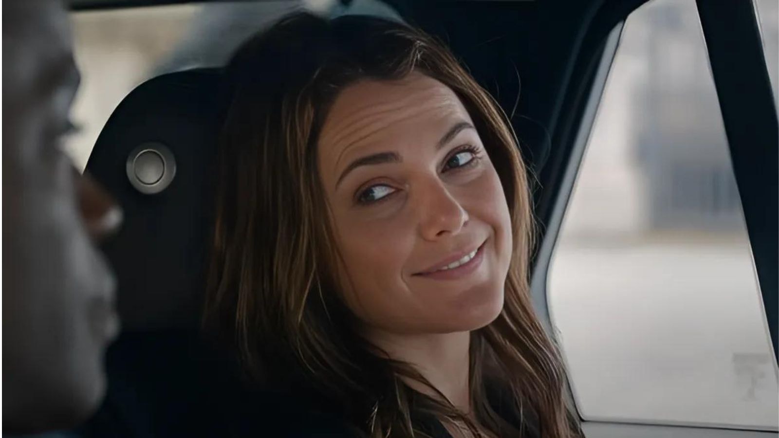 Keri Russell as Kate Wyler smiling while seated in a car