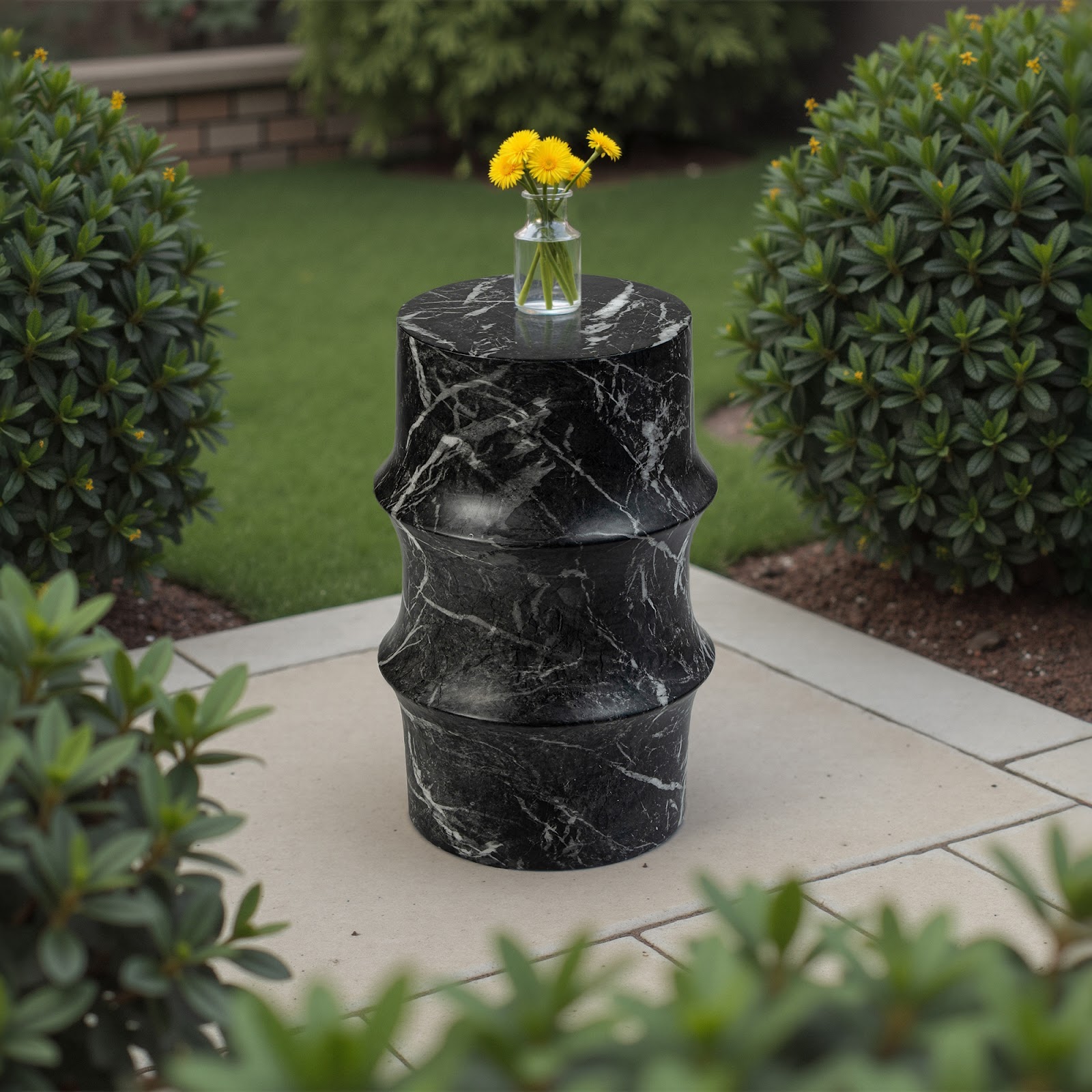 Grover Outdoor Faux Marble Sculptural Side Table with a bold black marble-look finish and hourglass-inspired curves, displayed in a landscaped garden—perfect as a functional art piece for contemporary patios or outdoor seating areas.