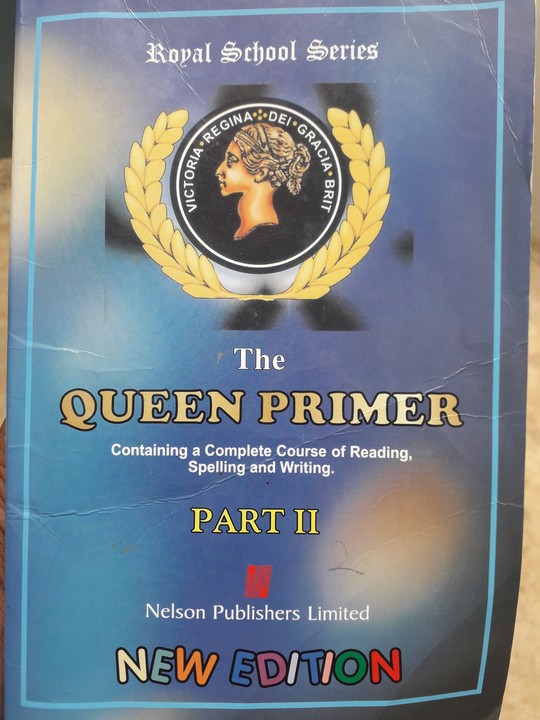 A well-used copy of The Queen Primer Part II, a Royal School Series exercise book