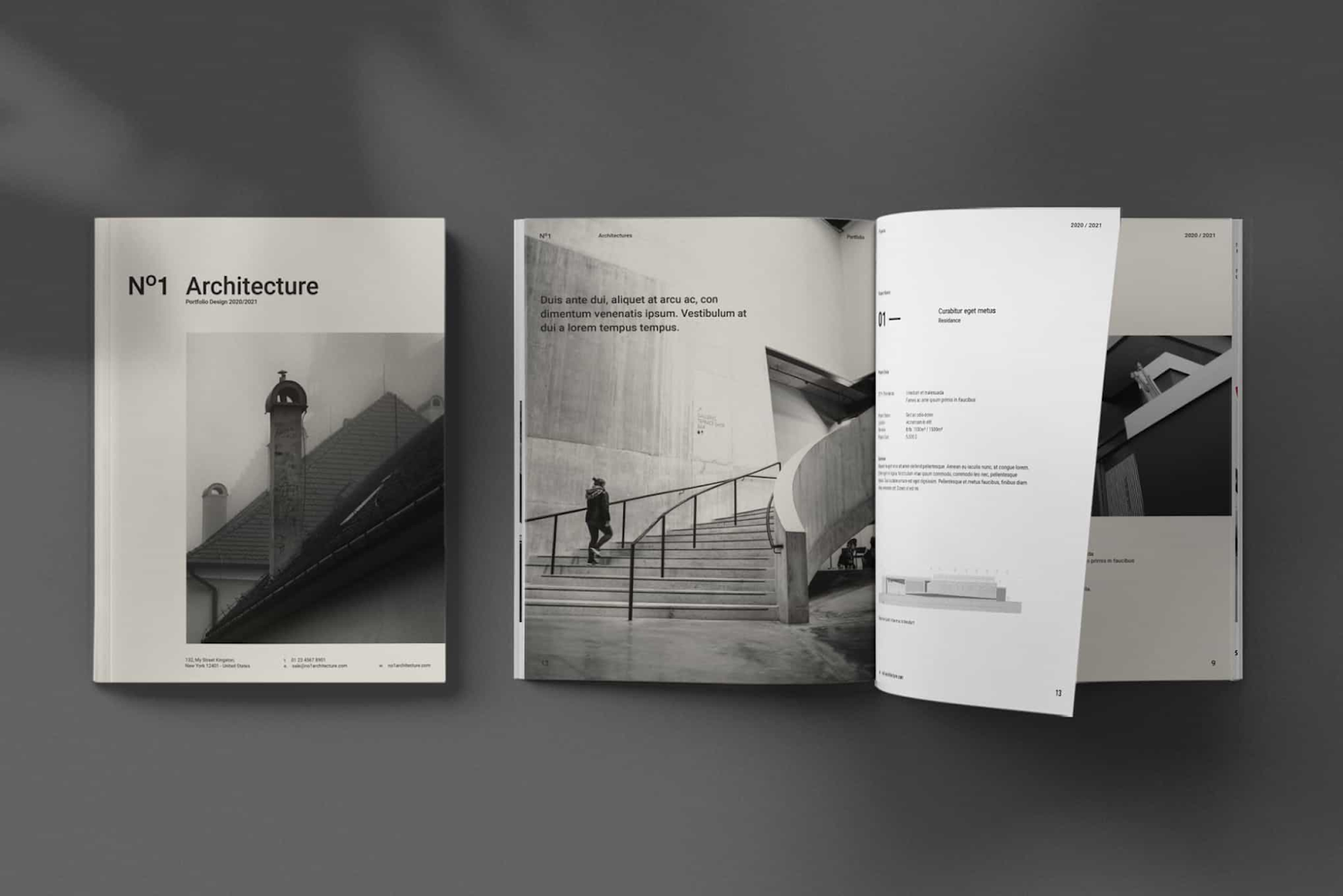 An open architecture portfolio lies on a flat surface next to a closed copy.